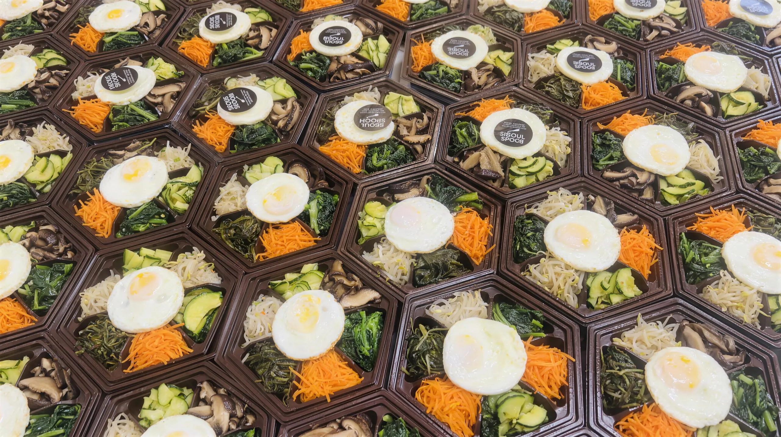 Bibimbap dosirak boxes topped with fried eggs